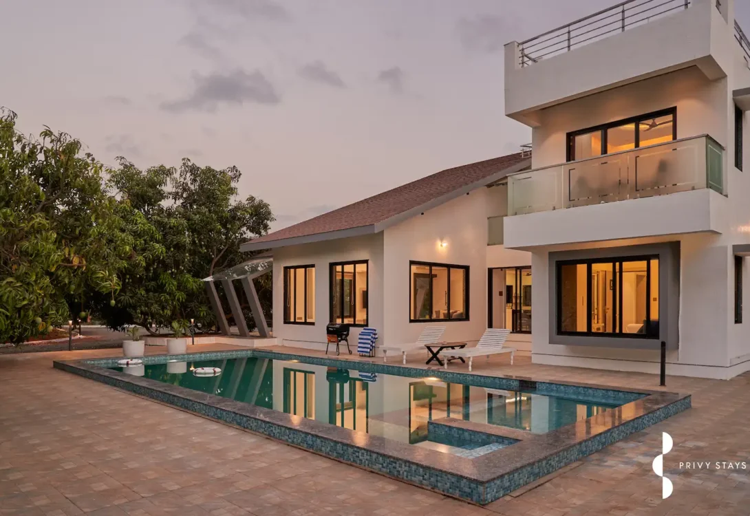 Outdoor pool area with greenery at a private villa in Alibag- near Mandwa Jetty